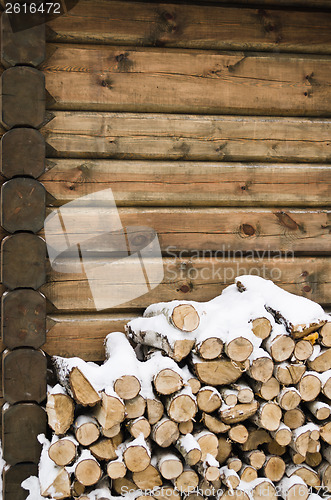 Image of Birch fire wood at a wall of the house in winter