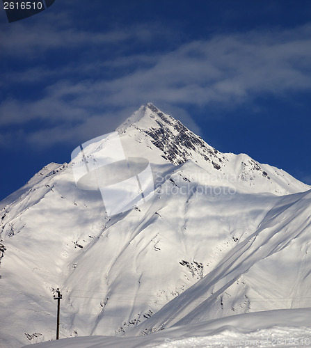 Image of Ski slope and blue sky with clouds at sunny day