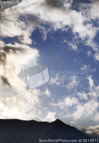 Image of Blue sky with clouds and mountains in evening