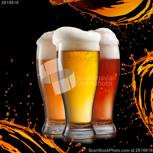 Image of Different beer in glasses wish splash isolated on black backgrou