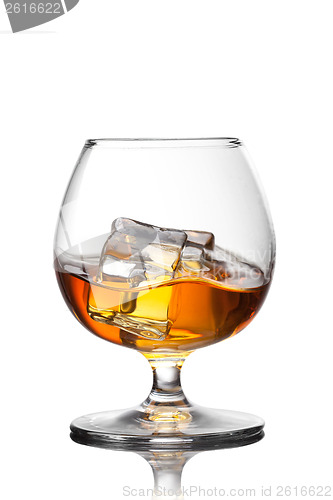 Image of Splash of whiskey with ice in glass isolated on white background