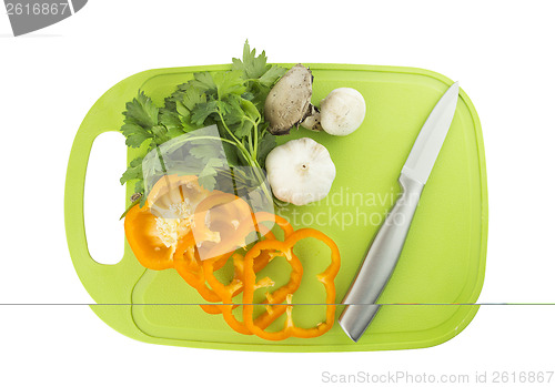 Image of Parsley and mushroom on green Plastic board