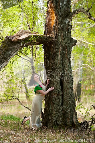 Image of Beautiful woman near birch