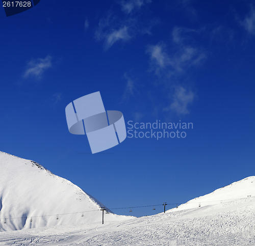 Image of Ski slope with chair lift at sunny winter day