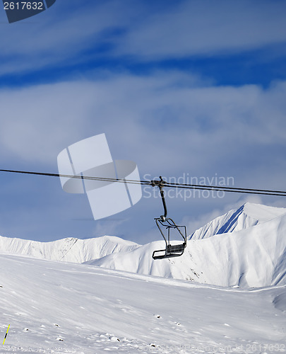 Image of Chair lift and off-piste slope at nice sun day