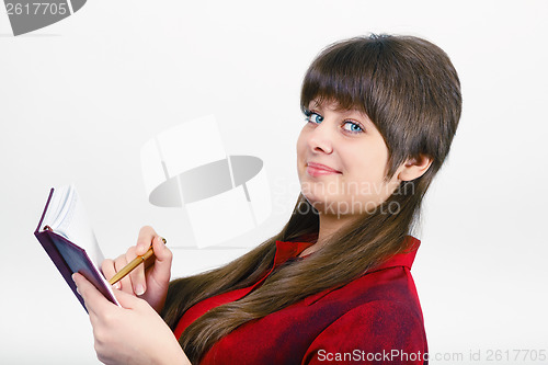 Image of young woman with a notepad and pen
