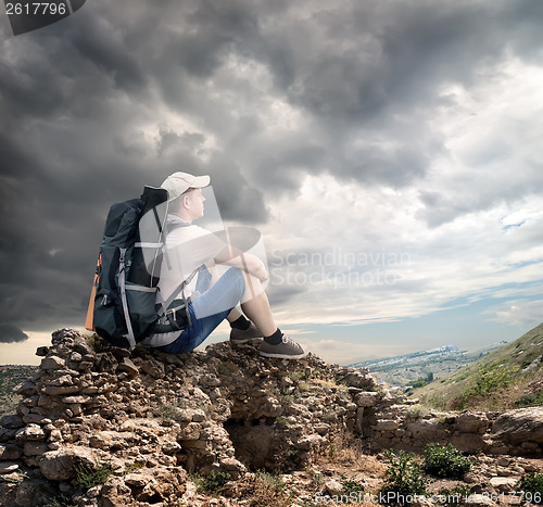 Image of Tourist sitting on the rocks