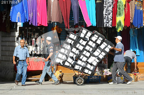 Image of Two men pushing a trolley