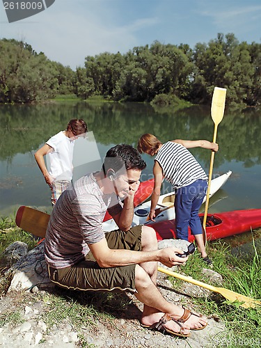 Image of men with canoe in nature l