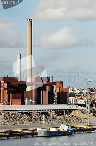 Image of industrial building and chimney and boat