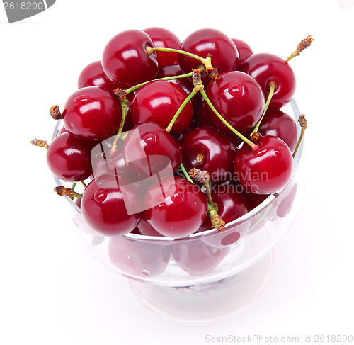 Image of Ripe fresh cherry in the glass isolated on white background