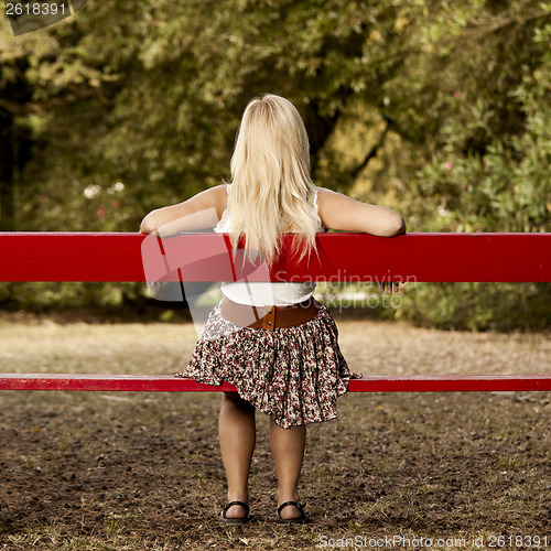 Image of Girl sitting on a park bench