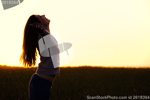 Image of Woman relaxing at sunset