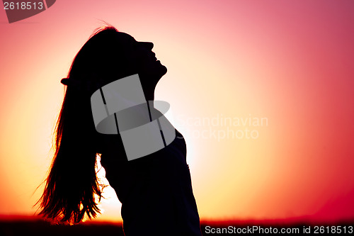 Image of Woman relaxing at sunset