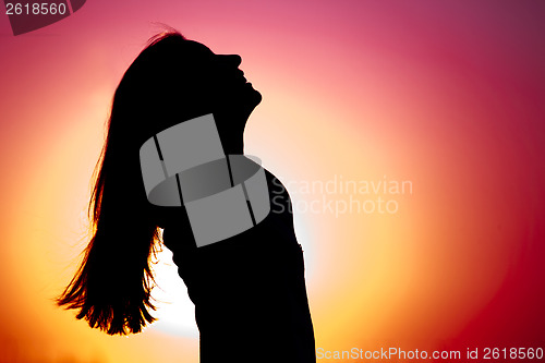 Image of Woman relaxing at sunset