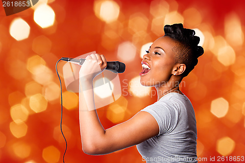 Image of Singing kareoke woman with microphone