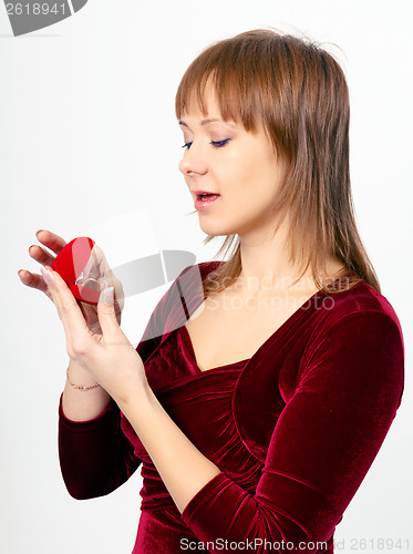 Image of young woman opens the ring box