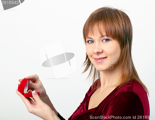 Image of young woman opens the ring box