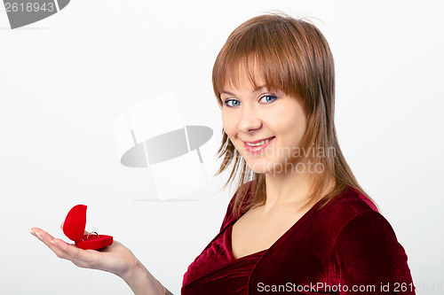 Image of young woman opens the ring box