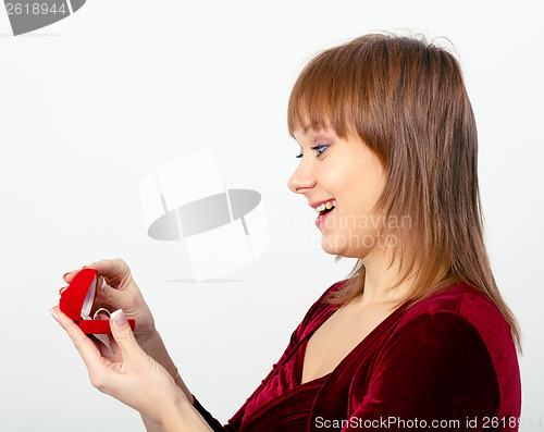 Image of young woman opens the ring box