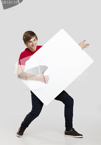 Image of Man holding a cardboard