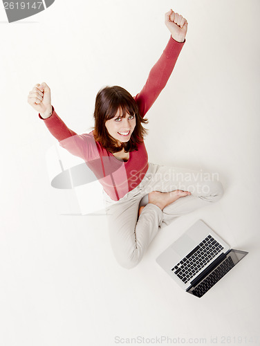 Image of Happy woman with a laptop