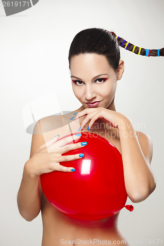 Image of Fashion woman with a red balloon