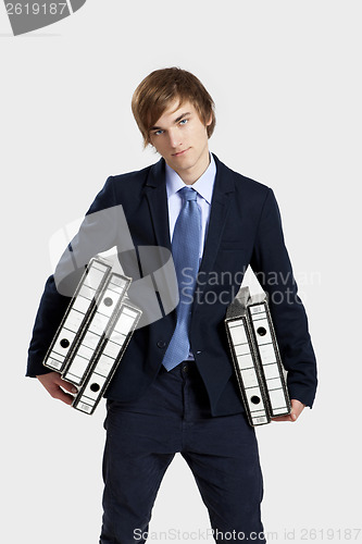 Image of Business man carrying folders