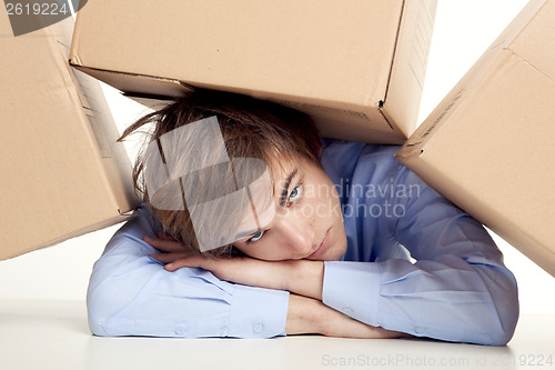 Image of Man under boxes