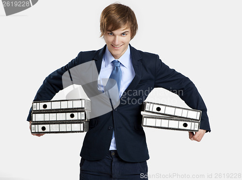 Image of Business man carrying folders