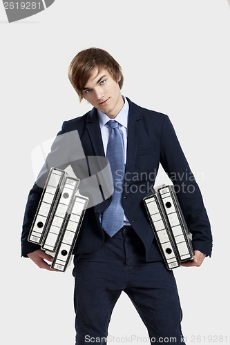 Image of Business man carrying folders