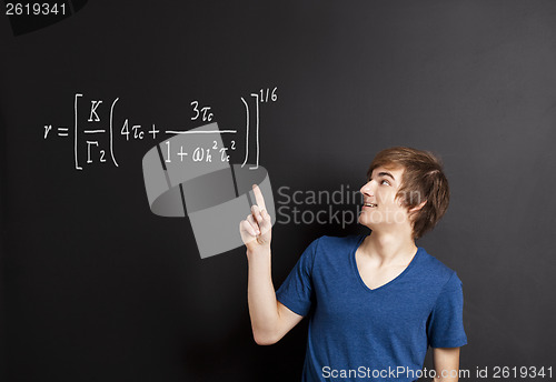 Image of Young man pointing to a equation