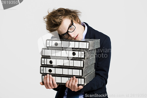 Image of Business man carrying folders