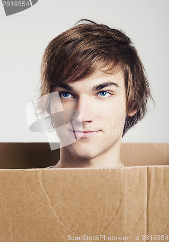 Image of Man inside a card box