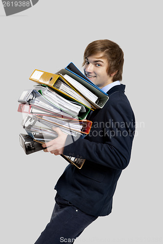 Image of Business man carrying folders