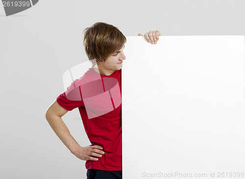 Image of Man holding a cardboard