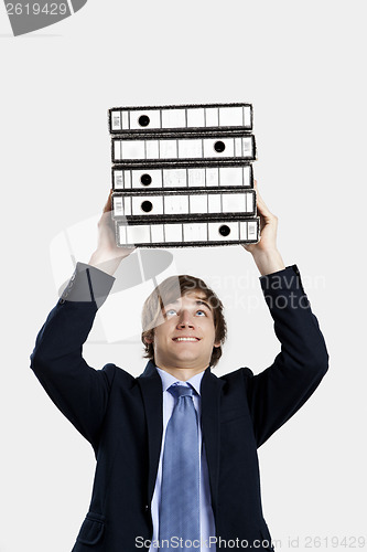 Image of Business man carrying folders