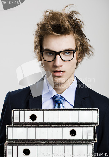 Image of Business man carrying folders