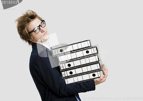 Image of Business man carrying folders