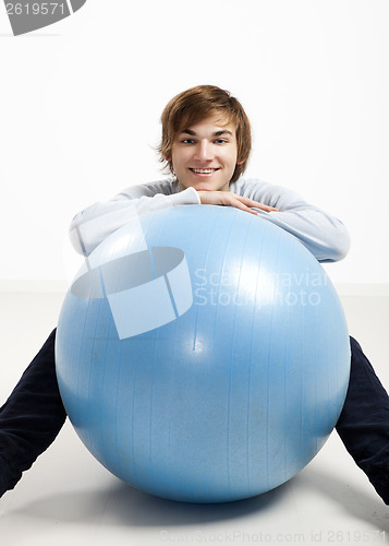 Image of Young man over a pilates ball