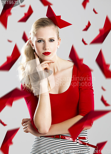 Image of Woman with red paper boats