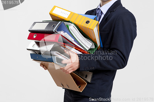 Image of Business man carrying folders