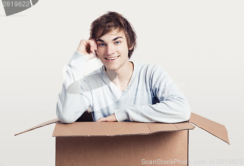 Image of Man inside a card box