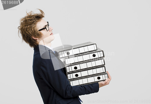 Image of Business man carrying folders