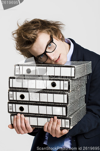 Image of Business man carrying folders