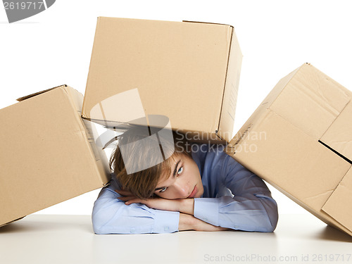 Image of Man under boxes