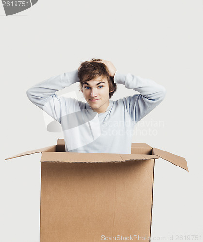 Image of Man inside a card box