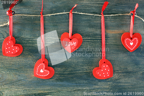 Image of Red hearts on a wooden wall.