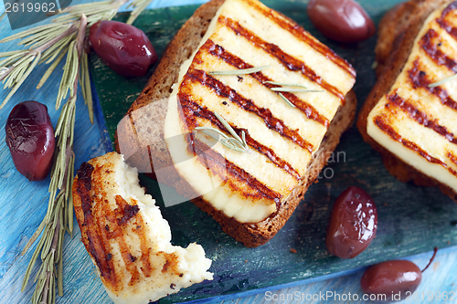 Image of Grilled cheese, olives, rosemary.