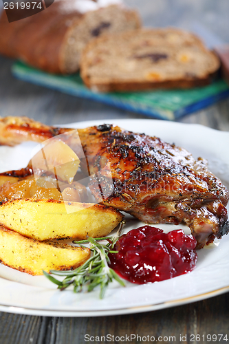 Image of Duck leg with apple and cowberry sauce.